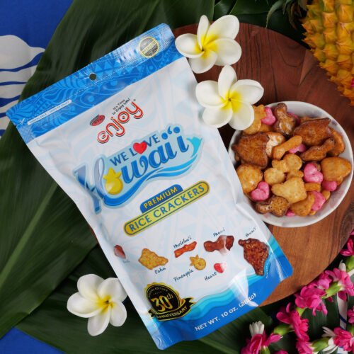 Bag of We Love Hawaii arare mix on a table with a bowl and flowers